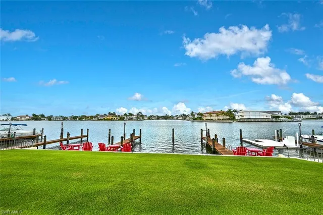 a view of a lake with houses in the back