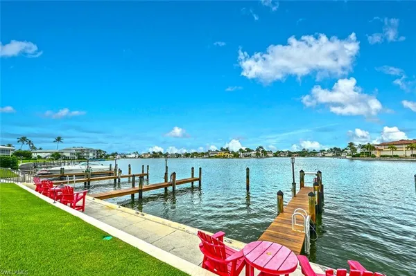 a view of a lake with houses in the back