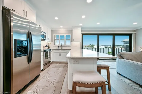 a kitchen with a refrigerator and a sink