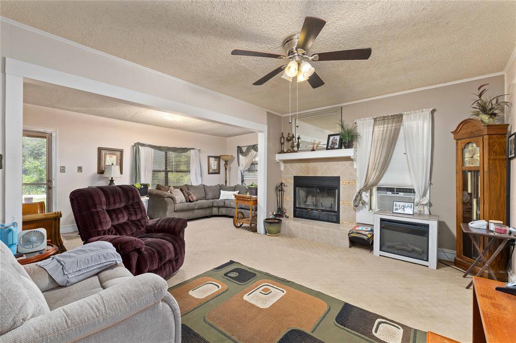3800 County Road 112 Brownwood, TX 76801 - Photo 12 of 37 Living room has a woodburning fireplace