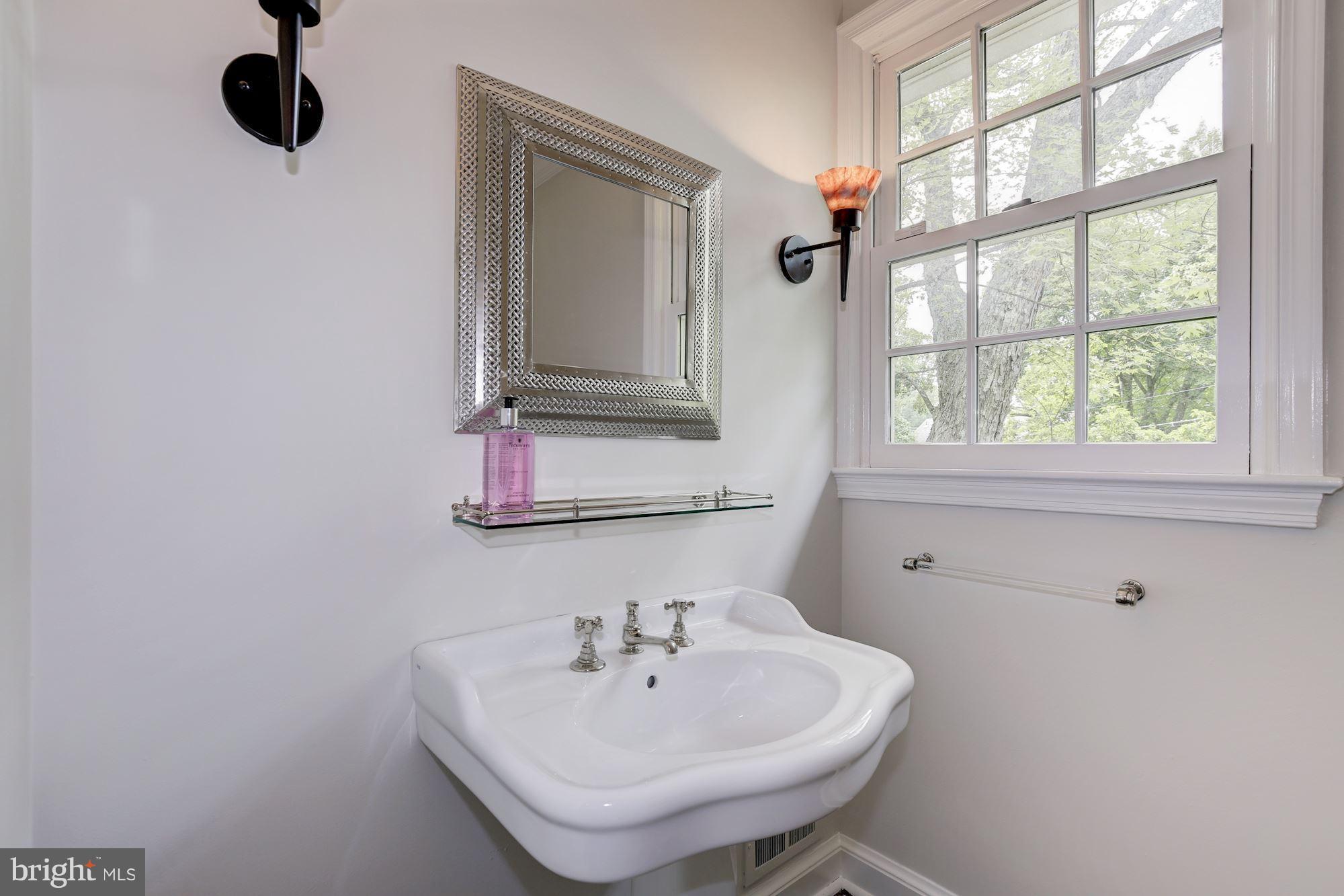 2205 46th Street Northwest Washington, DC 20007 - Photo 11 of 30 a bathroom with a sink and a mirror