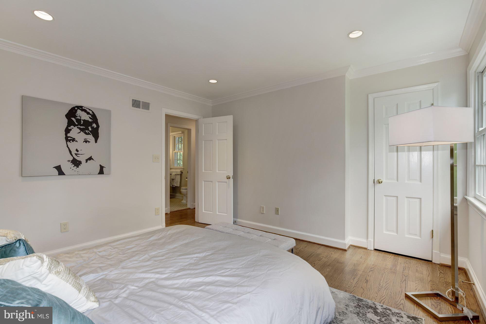 2205 46th Street Northwest Washington, DC 20007 - Photo 19 of 30 a bedroom with a bed and a painting on the wall