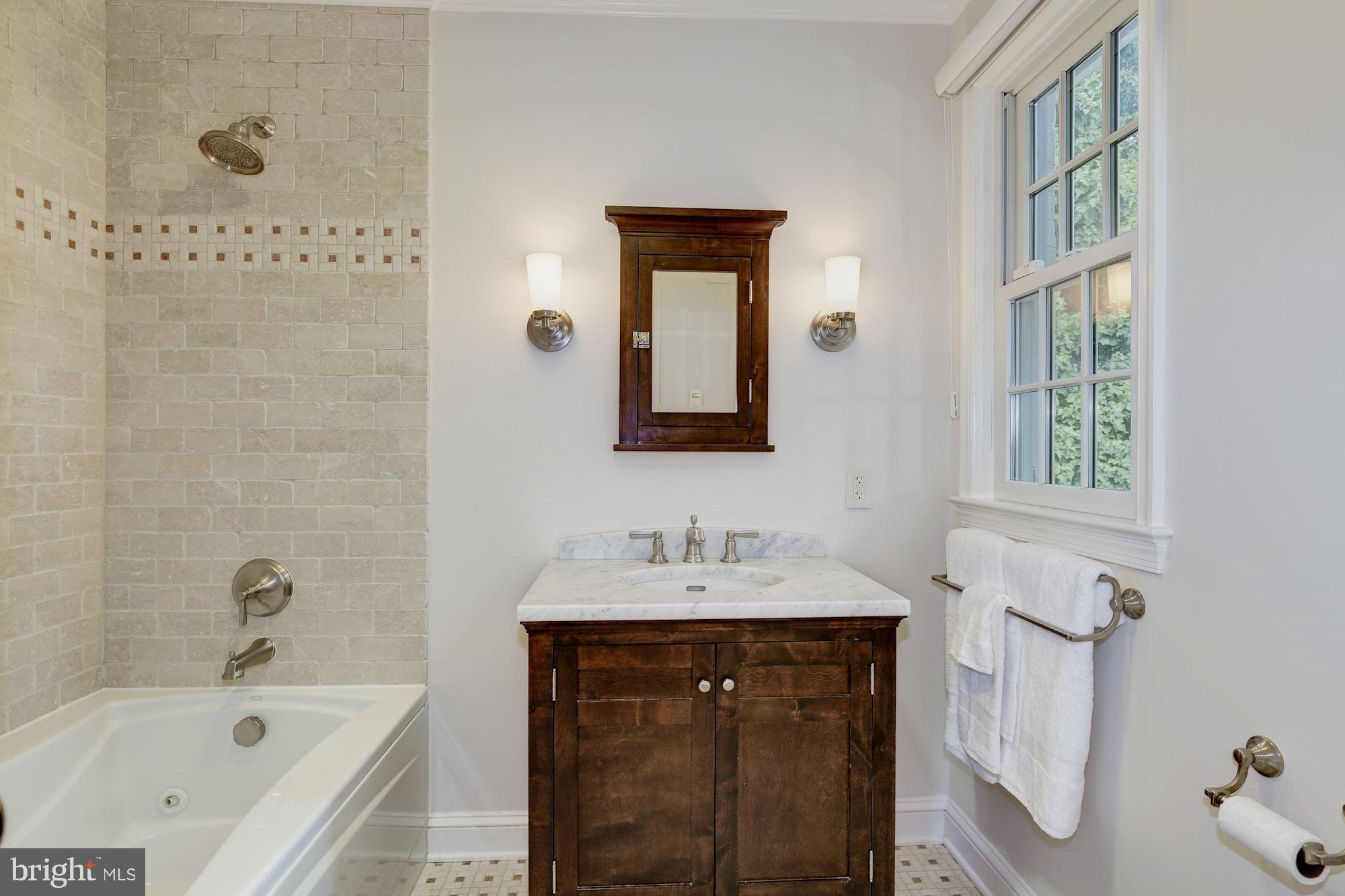 2205 46th Street Northwest Washington, DC 20007 - Photo 20 of 30 a bathroom with a tub sink and mirror