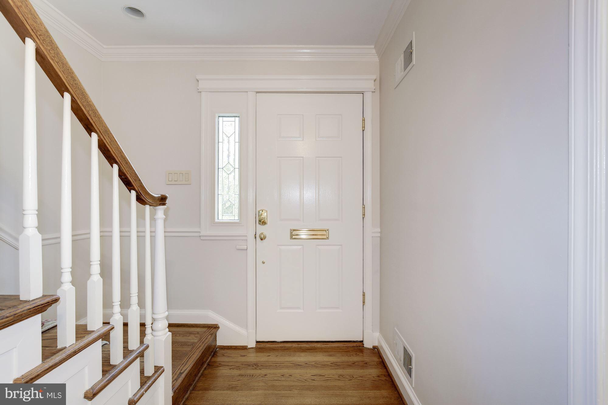 2205 46th Street Northwest Washington, DC 20007 - Photo 3 of 30 a view of a hallway with wooden floor and staircase