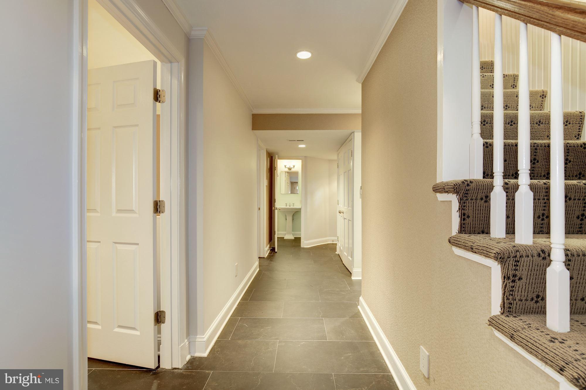 2205 46th Street Northwest Washington, DC 20007 - Photo 23 of 30 a view of a hallway with wooden floor and staircase
