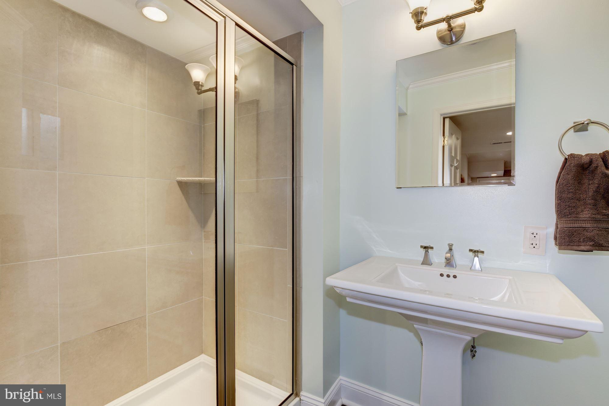 2205 46th Street Northwest Washington, DC 20007 - Photo 26 of 30 a bathroom with a sink and a mirror