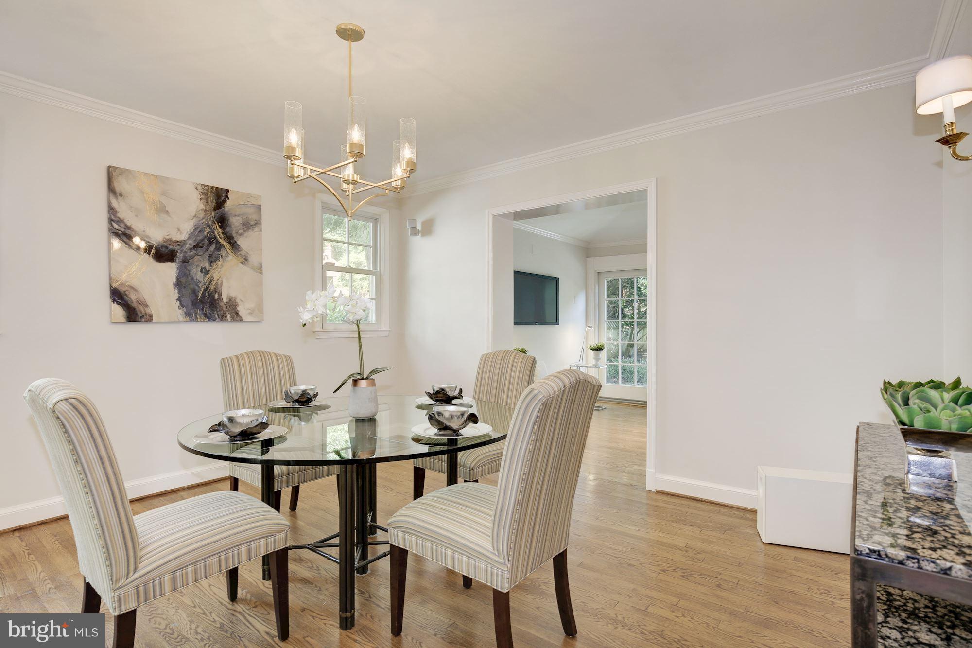 2205 46th Street Northwest Washington, DC 20007 - Photo 6 of 30 a dining room with furniture a chandelier and wooden floor