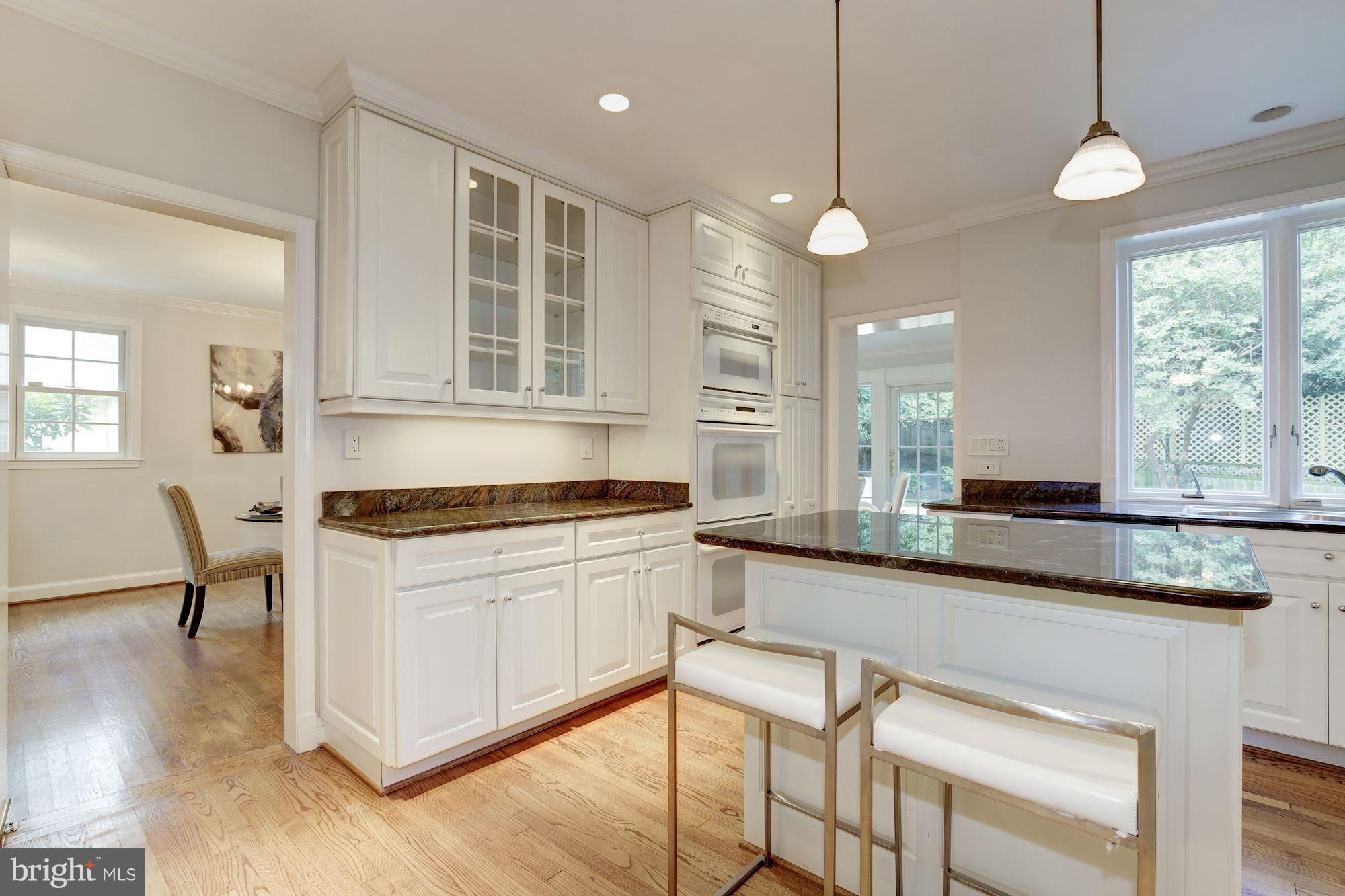 2205 46th Street Northwest Washington, DC 20007 - Photo 8 of 30 a kitchen with stainless steel appliances granite countertop a stove a sink and a refrigerator