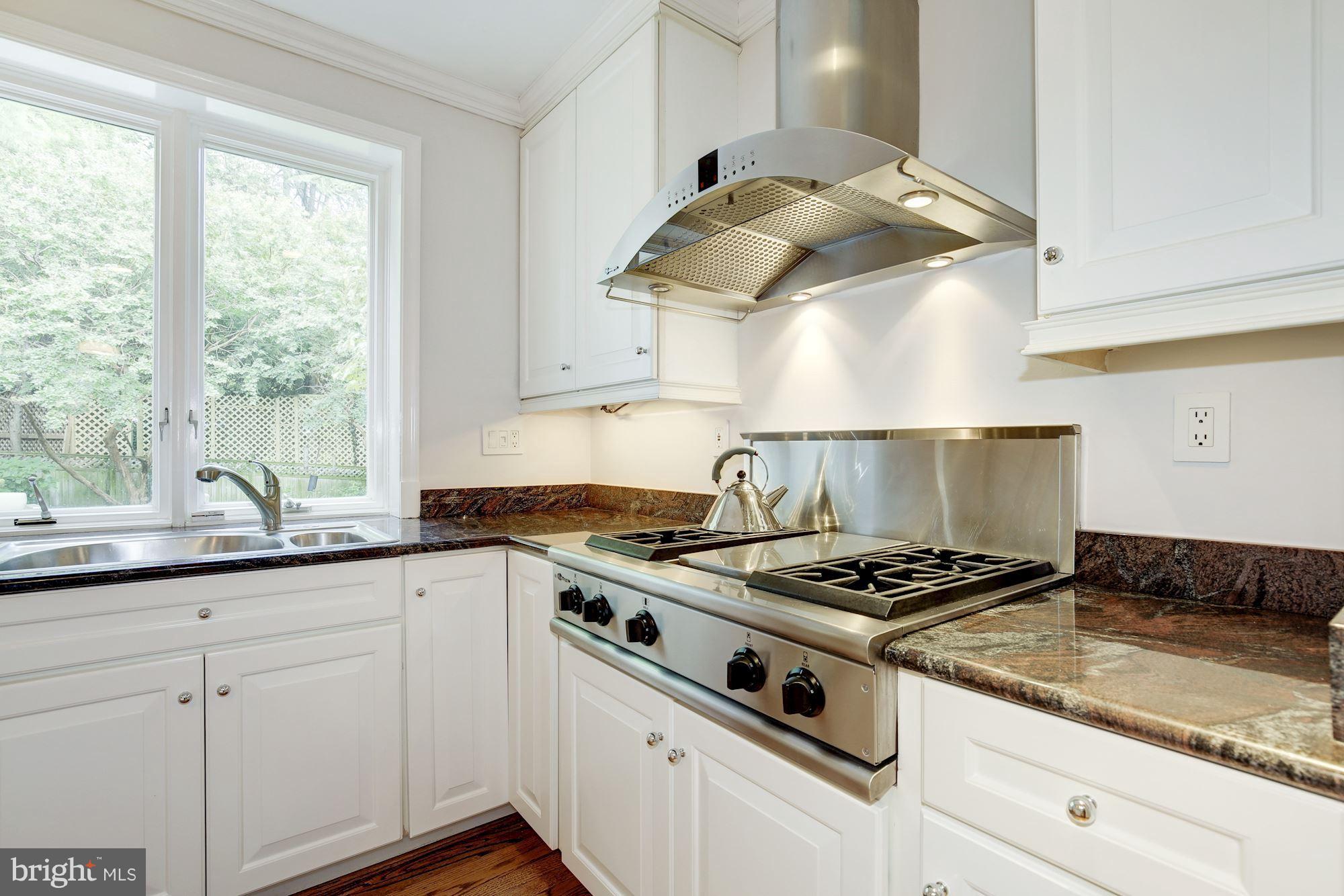 2205 46th Street Northwest Washington, DC 20007 - Photo 9 of 30 a kitchen with granite countertop a stove and a sink