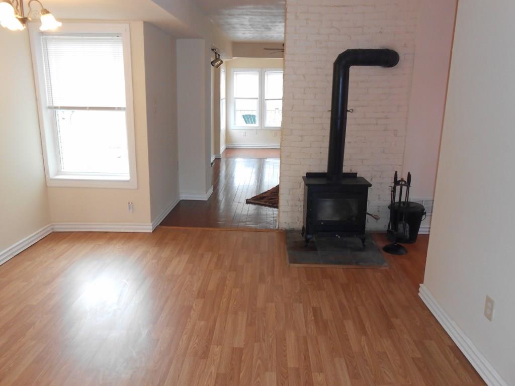 173 Varsity Road Masontown, PA 15461 - Photo 3 of 21 Dining room with wood stove and laminated flooring.