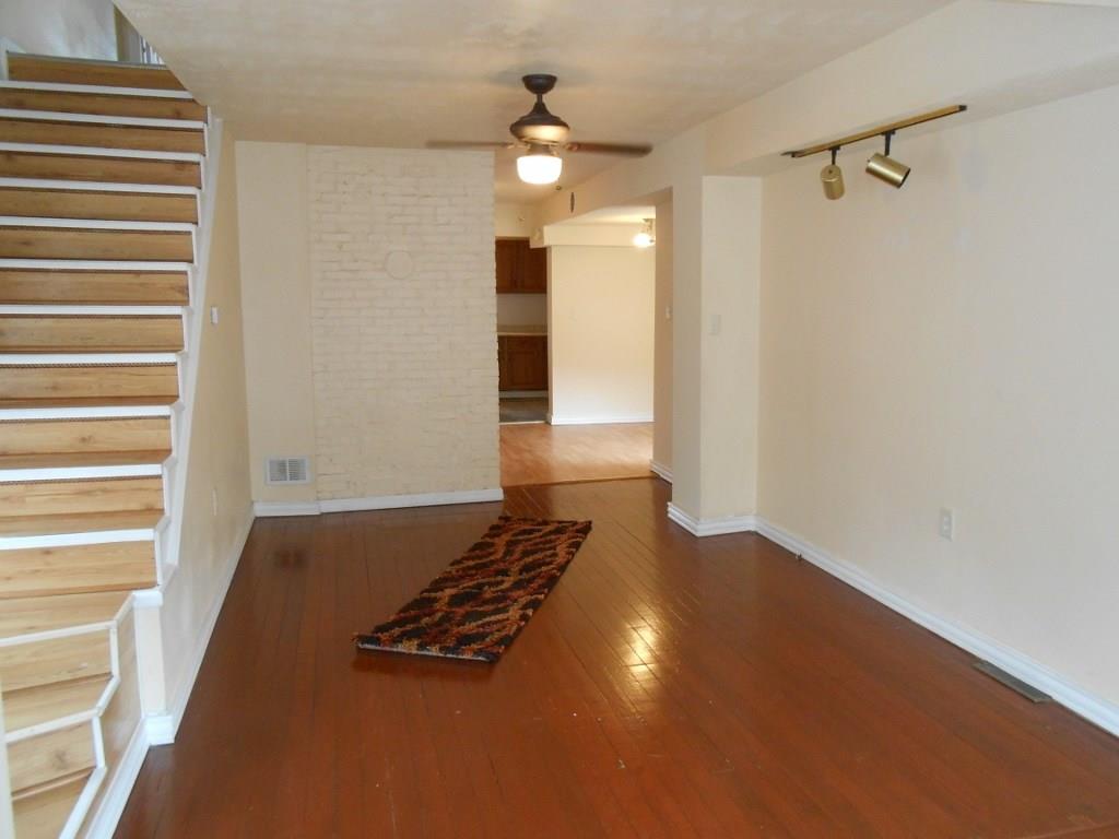 173 Varsity Road Masontown, PA 15461 - Photo 5 of 21 Living room with hardwood and exposed brick.