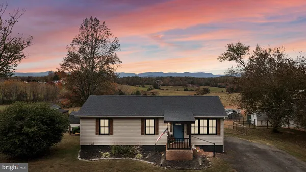 a aerial view of a house with a yard table and chairs