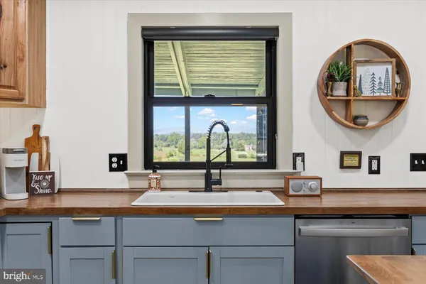 a kitchen with stainless steel appliances granite countertop a sink and stove top oven