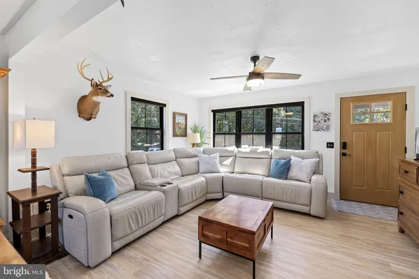 a large kitchen with a table chairs refrigerator and wooden floor