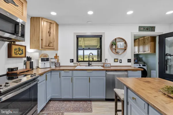 a large kitchen with a table and chairs