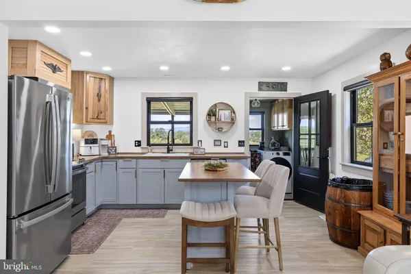 a kitchen with stainless steel appliances a refrigerator stove and microwave