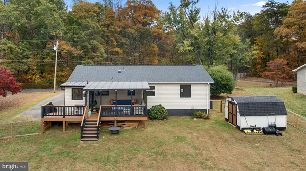 a aerial view of a house with table and chairs under an umbrella