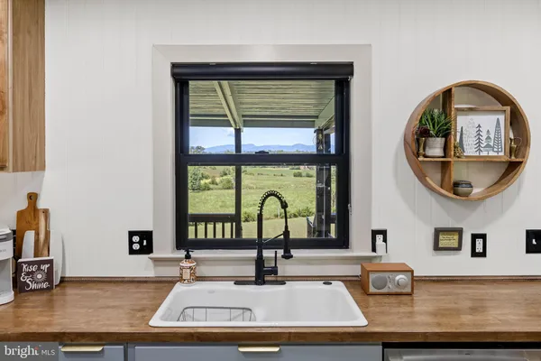 a kitchen with granite countertop a refrigerator and a sink
