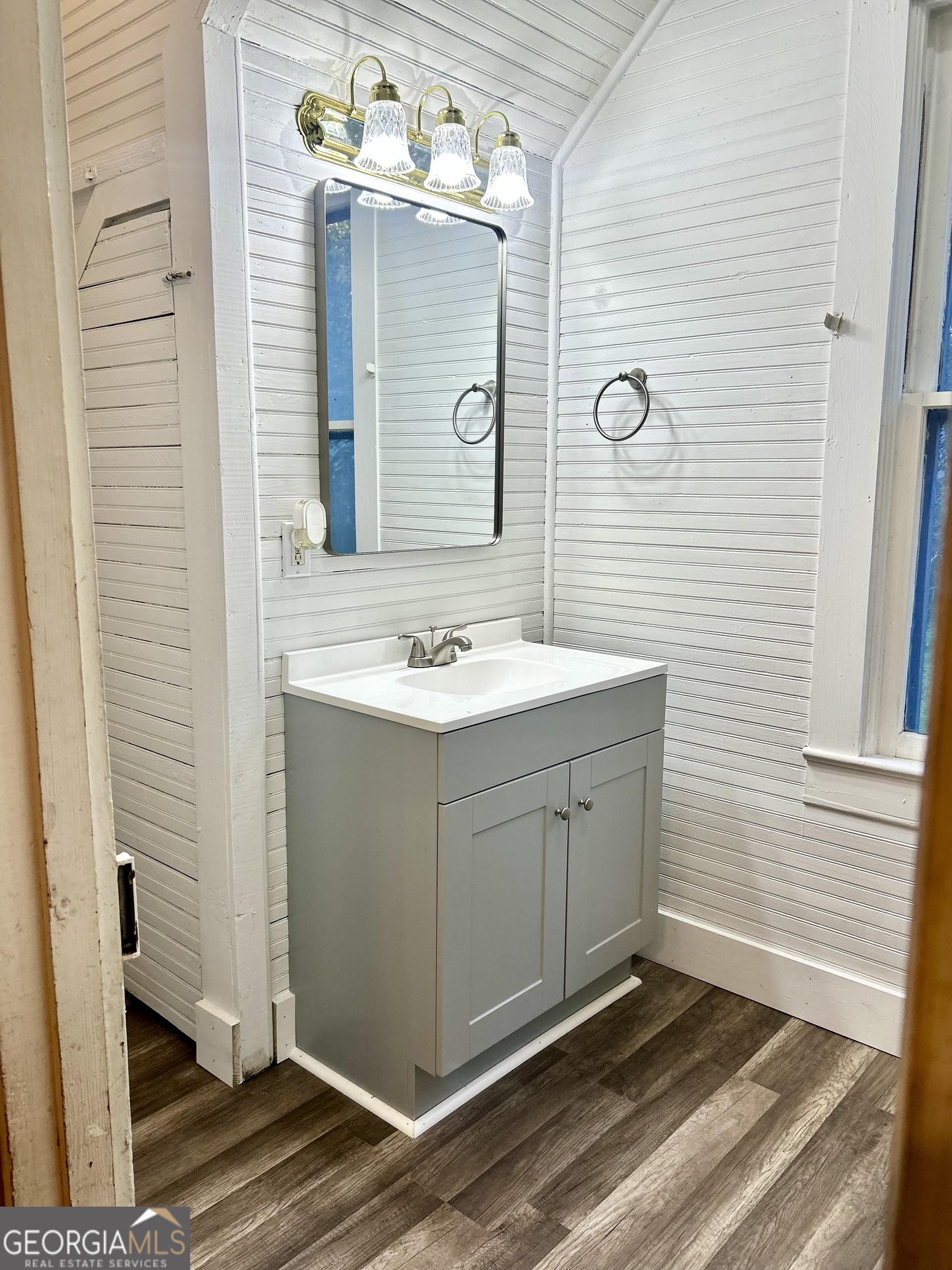 2123 Ellis Street Brunswick, GA 31520 - Photo 14 of 19 a bathroom with a sink a mirror and a shower