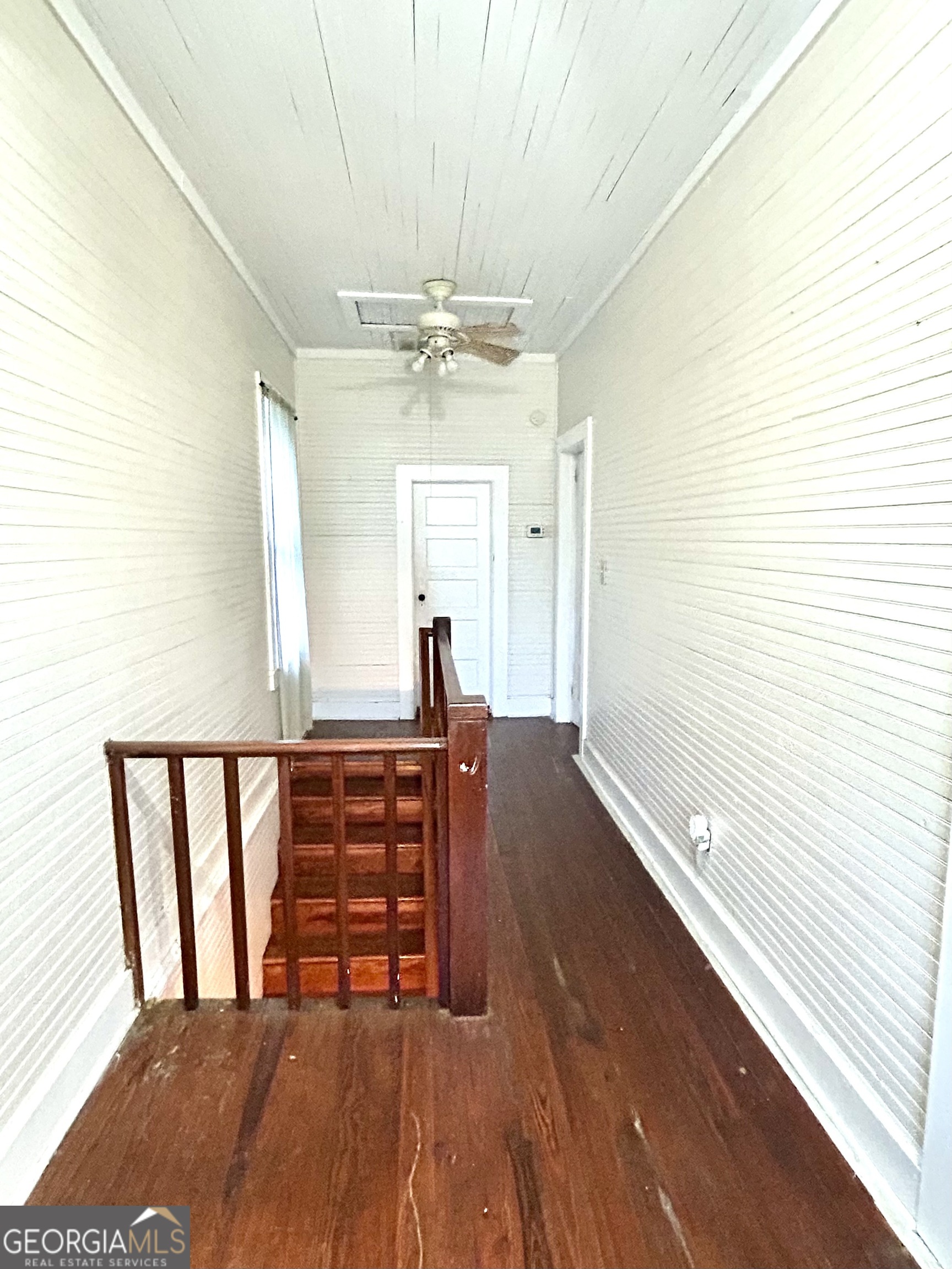 2123 Ellis Street Brunswick, GA 31520 - Photo 18 of 19 a view of a hallway with wooden floor and chandelier