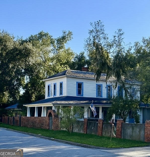 2123 Ellis Street Brunswick, GA 31520 - Photo 2 of 19 a front view of a house with a garden