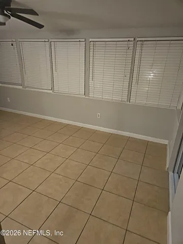 a view of an empty room and a window