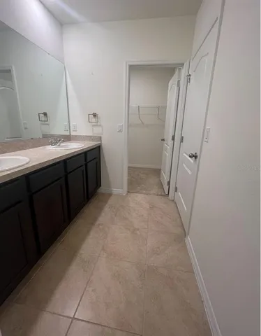 a bathroom with a double vanity sink and mirror