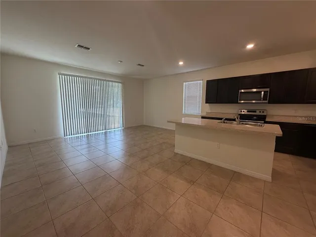 a view of kitchen appliances and cabinets