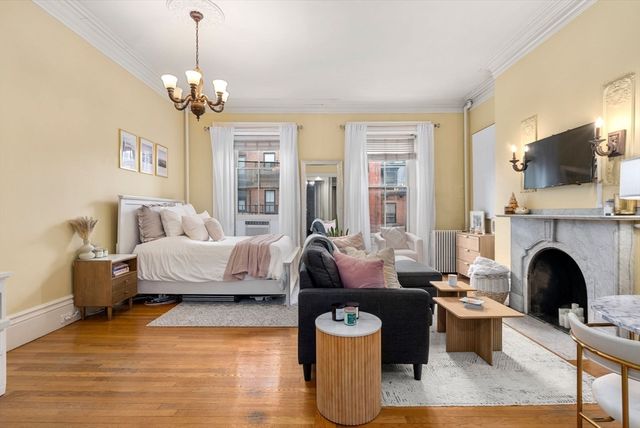 a living room with furniture fireplace and flat screen tv