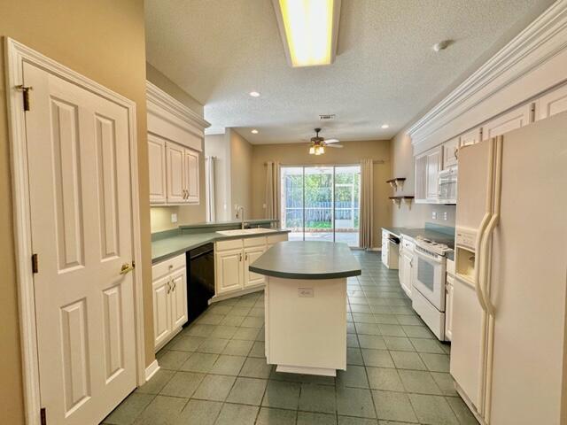 2024 Grayson Drive Navarre, FL 32566 - Photo 10 of 47 a kitchen with stainless steel appliances granite countertop a refrigerator and a sink