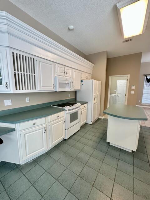 2024 Grayson Drive Navarre, FL 32566 - Photo 12 of 47 a kitchen with cabinets and white appliances