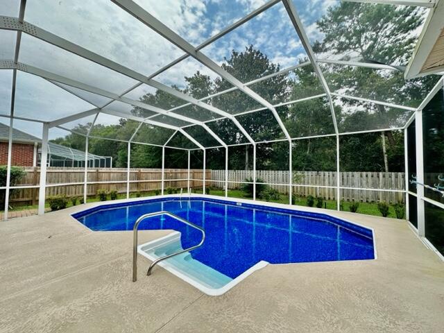 2024 Grayson Drive Navarre, FL 32566 - Photo 34 of 47 a view of a swimming pool with a lounge chairs
