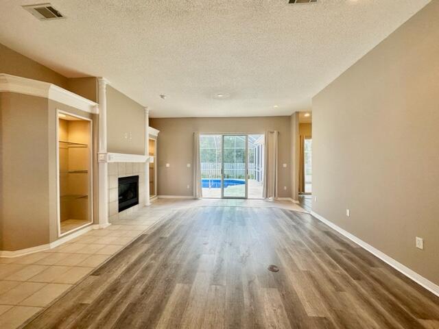 2024 Grayson Drive Navarre, FL 32566 - Photo 4 of 47 a view of empty room with wooden floor and fireplace