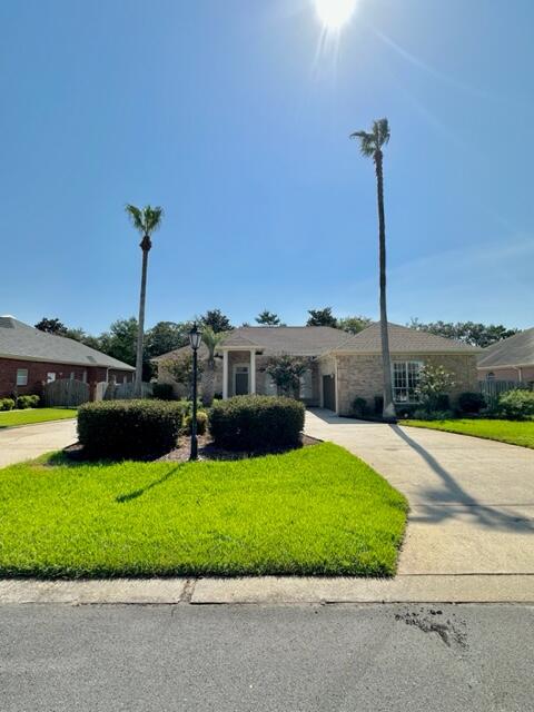 2024 Grayson Drive Navarre, FL 32566 - Photo 43 of 47 a view of a patio with a table and chairs