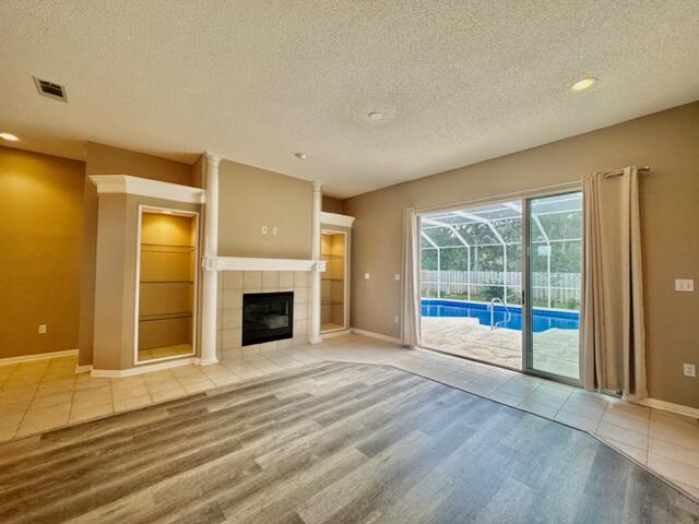 2024 Grayson Drive Navarre, FL 32566 - Photo 5 of 47 a view of an empty room with a fireplace and a window