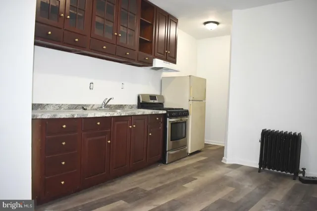 a kitchen with stainless steel appliances granite countertop a refrigerator and a sink