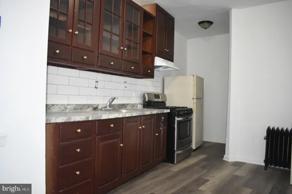 a kitchen with stainless steel appliances granite countertop a sink and a stove