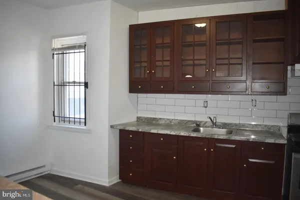 a kitchen with a sink and cabinets
