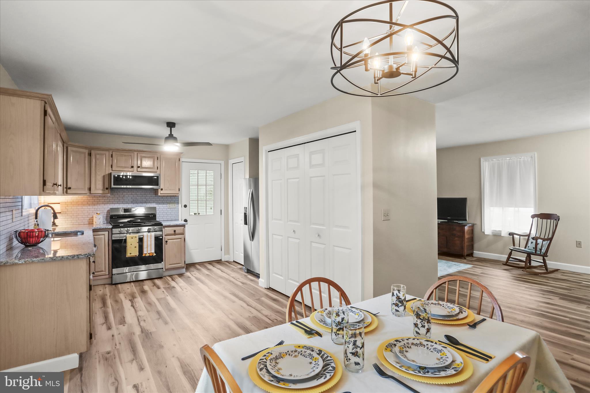 8 Magnolia Lane Hanover, PA 17331 - Photo 11 of 38 a kitchen with stainless steel appliances granite countertop a stove a kitchen island a dining table and chairs with wooden floor