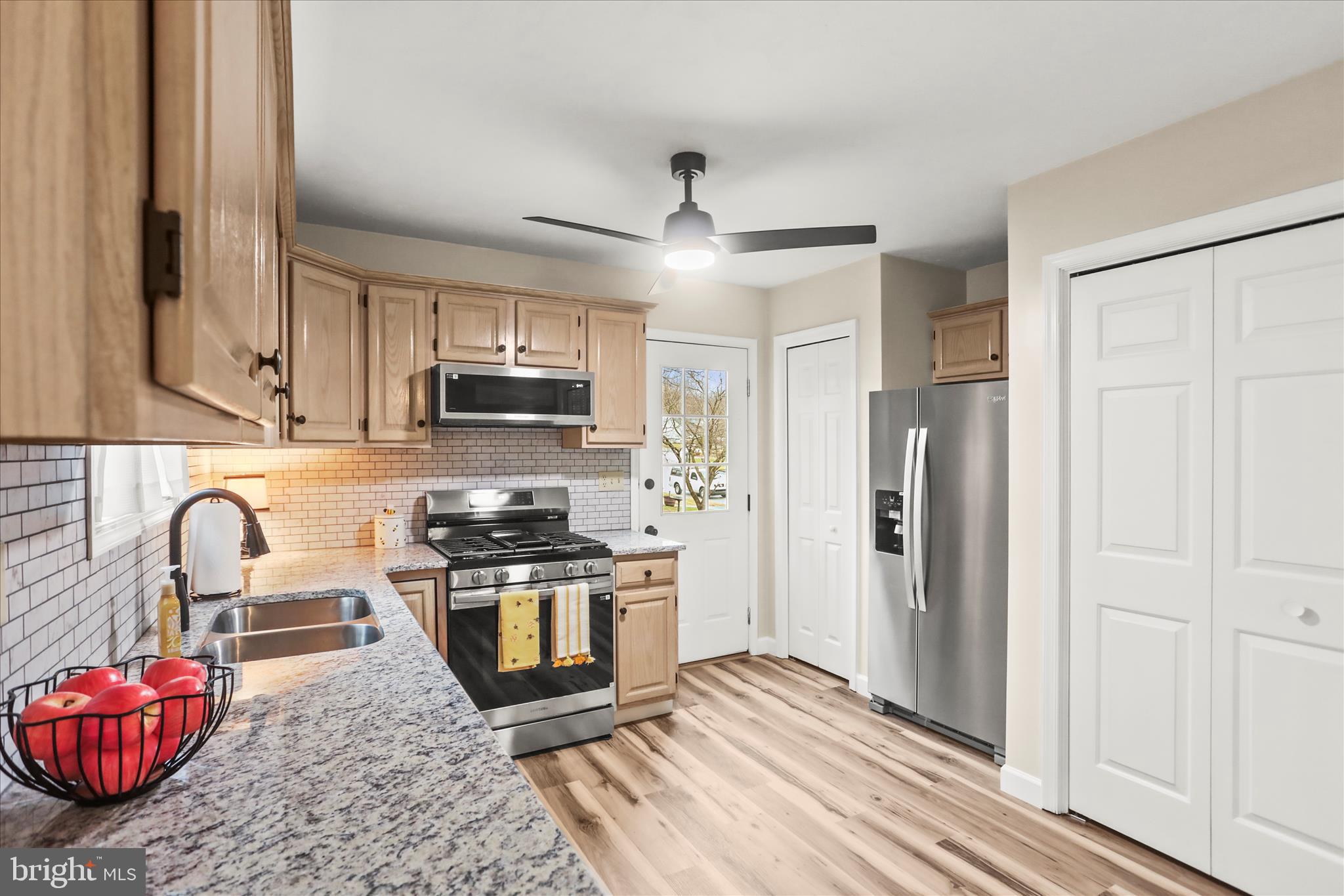 8 Magnolia Lane Hanover, PA 17331 - Photo 13 of 38 a kitchen with stainless steel appliances granite countertop a stove top oven a sink dishwasher and a refrigerator with wooden floor