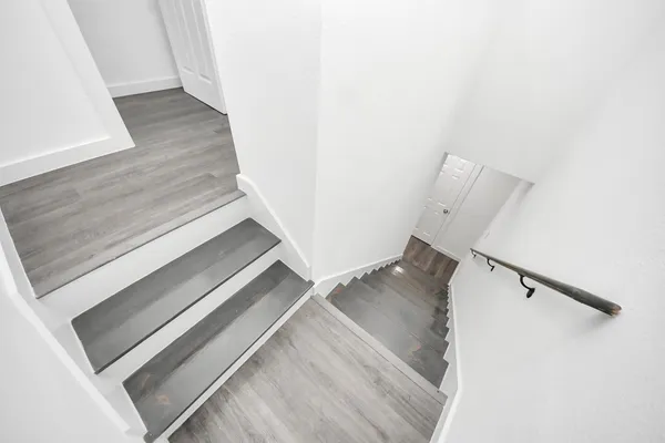 a view of staircase with white walls