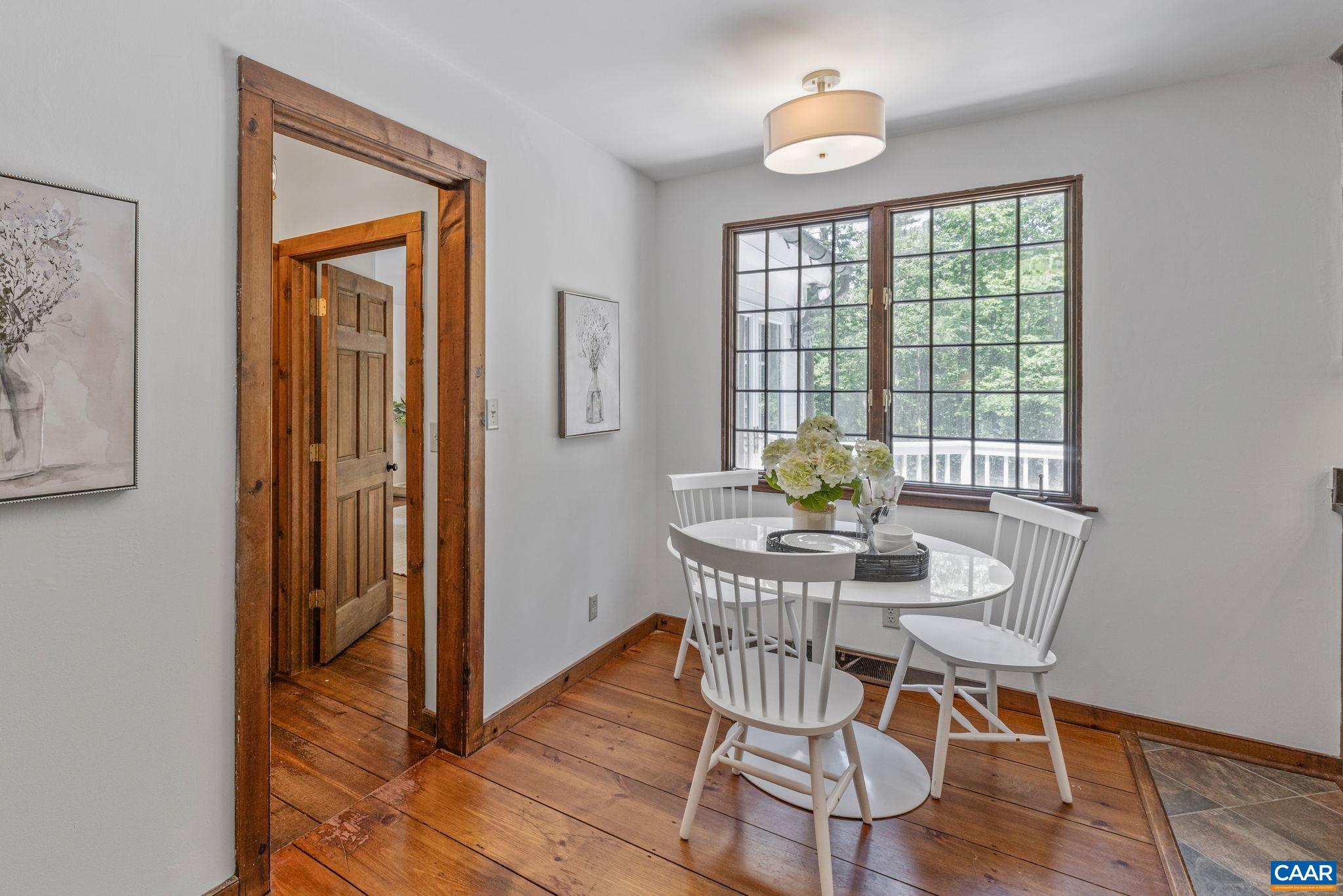 2175 Fray Road Ruckersville, VA 22968 - Photo 16 of 75 a view of a dining room with furniture window and wooden floor