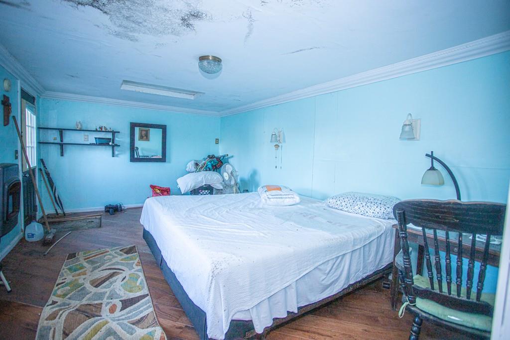 75 Cobb Hill Road Phillipston, MA 01331 - Photo 15 of 42 a bedroom with a bed and wooden floor