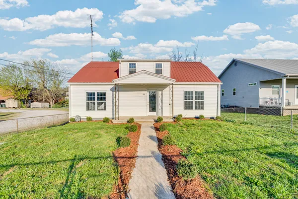 a front view of a house with a yard