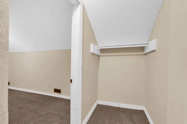 a view of closet with wooden floor