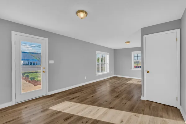 an empty room with windows and entrance