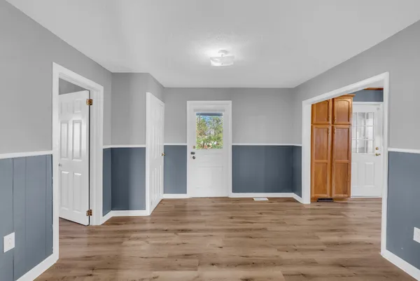 a view of empty room with wooden floor