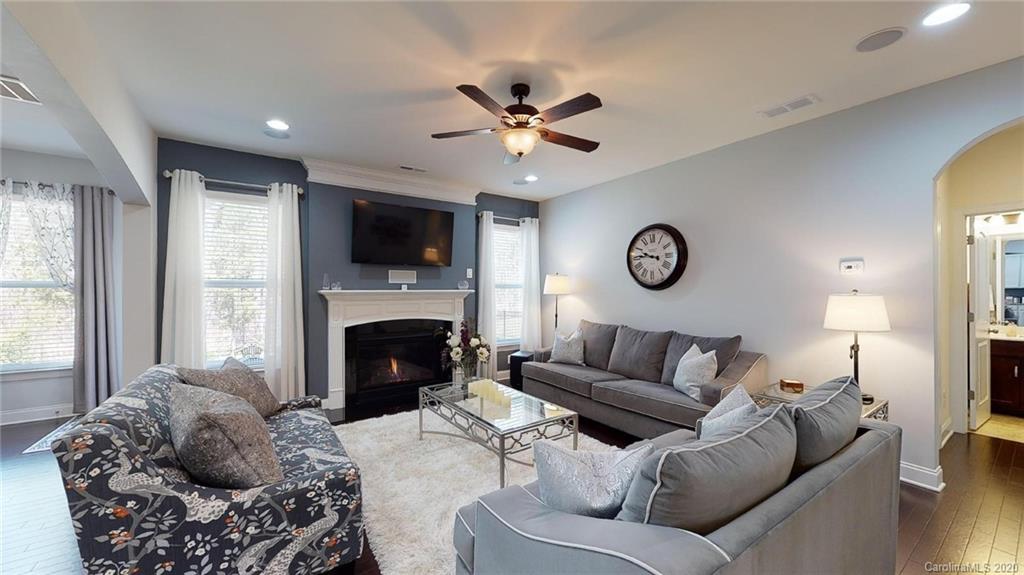 6018 Fallondale Road Waxhaw, NC 28173 - Photo 16 of 48 a living room with furniture a fireplace and a flat screen tv