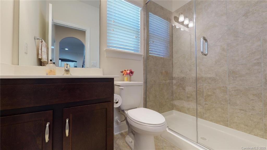 6018 Fallondale Road Waxhaw, NC 28173 - Photo 22 of 48 a bathroom with a sink vanity mirror and toilet
