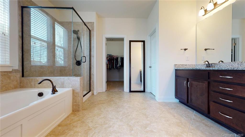 6018 Fallondale Road Waxhaw, NC 28173 - Photo 25 of 48 a bathroom with a tub sink and mirror